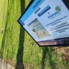 Outdoor sign telling readers to enjoy story walk. 