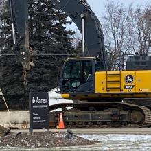 Construction vehicle and cone at the Vernon Area Public Library