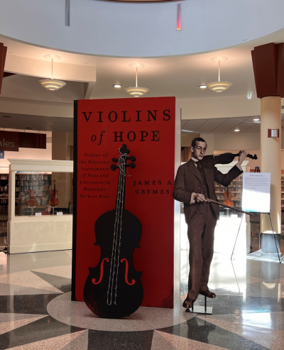 Promo poster with violin and a cutout of a man playing the violin