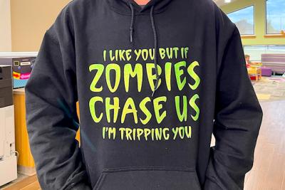 Someone wearing a sweatshirt that says "I like you, but if zombies chase us, I'm tripping you."