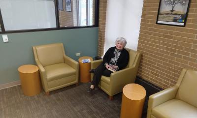 Library visitor sitting in an armchair.