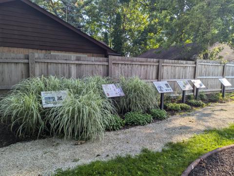StoryWalk boards and garden on stone walking path