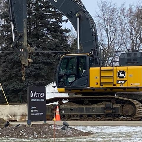 Construction vehicle and cone at the Vernon Area Public Library